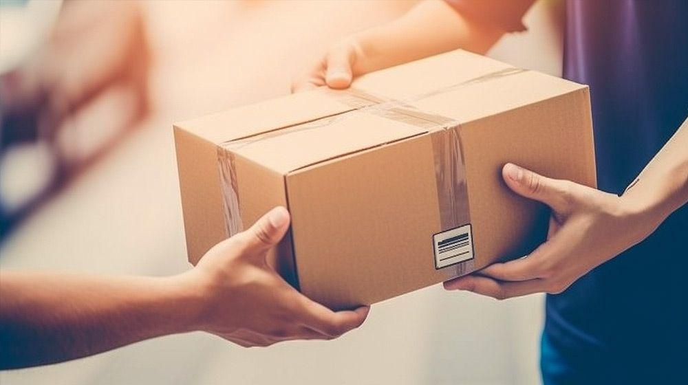 Delivery process, a package delivered, hands holding the package